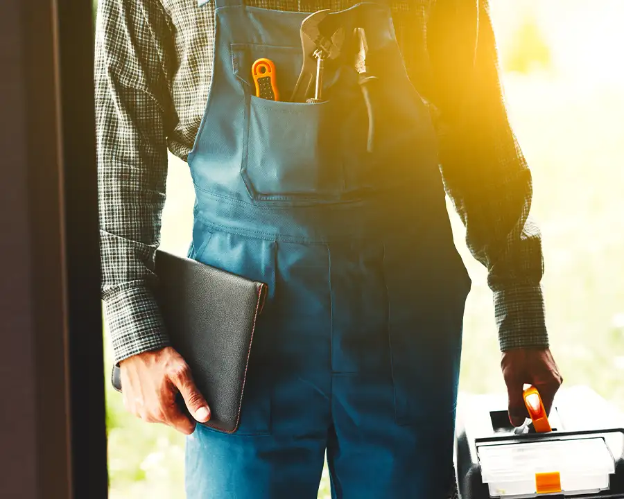 Electrician arriving at a home with a toolbox and notebook ready for an electrical service call — JSE Service and Electric LLC, O'Fallon, IL and St. Louis, MO